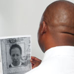 The Justicia undercover investigator who holds up the scammed identity document for a women who has defrauded several large companies and individuals of hundreds and thousands of rands. We ask anyone who recognises this person to come forward and assist in the identification.